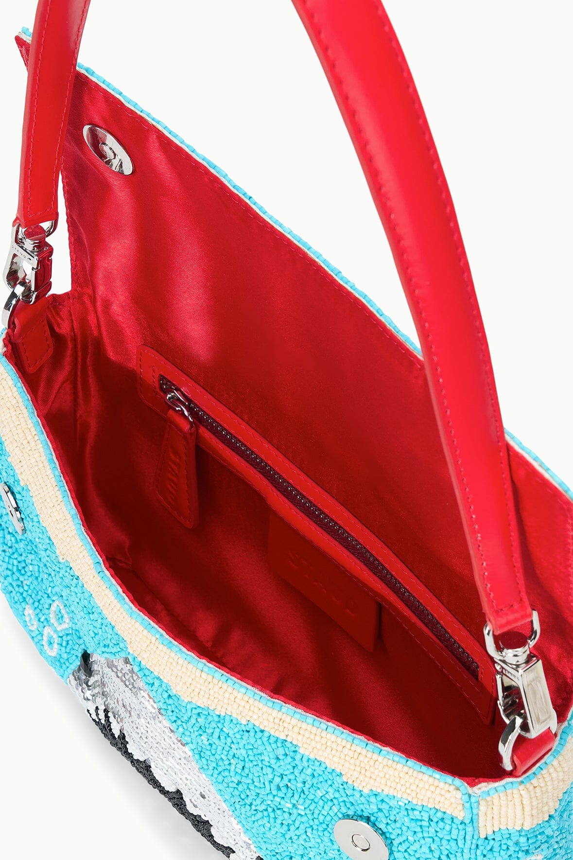 Turquoise sequin shoulder bag open view with red-lined interior and zipper.