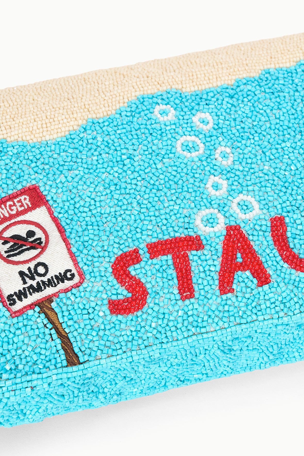 Turquoise sequin bag panel with “NO SWIMMING” shark graphic patch.