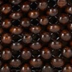 Close-up of dark brown round beads on a beaded shoulder bag