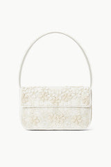 White beaded mini handbag with top handle, front flap, and zipper closure.
