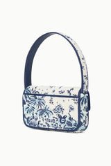 Angled view of small blue-and-cream toile beaded bag with top handle