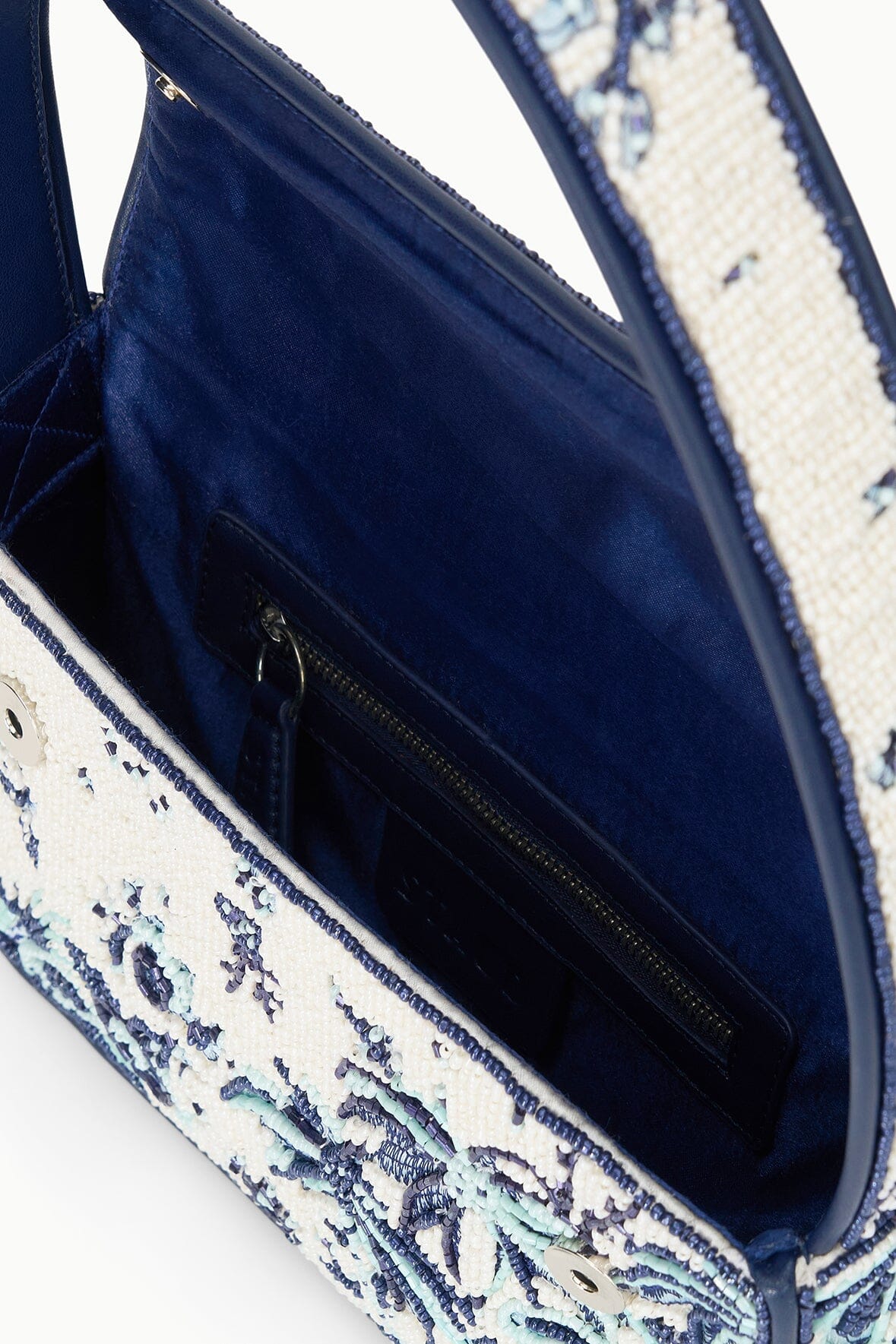 Beaded bag interior with dark blue lining and visible zipper pocket