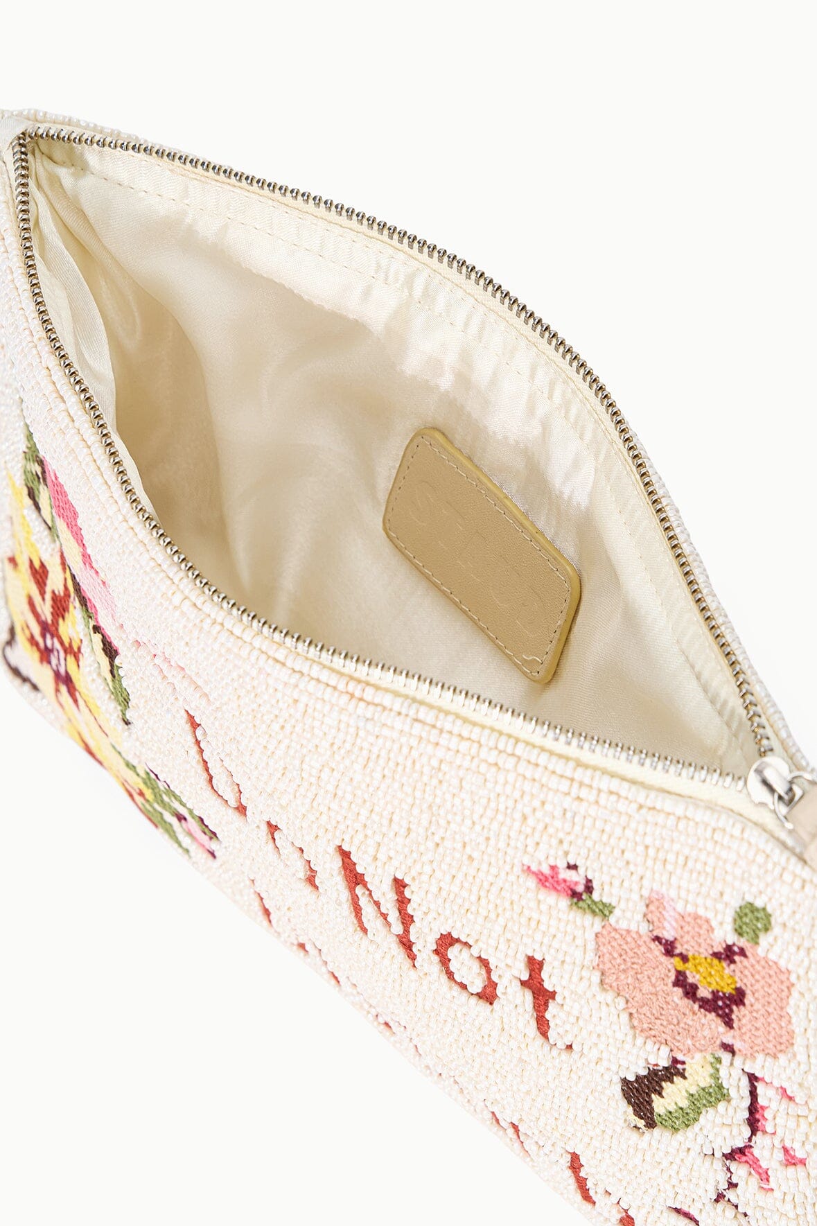 Beaded pouch interior with zipper opening and tan logo patch