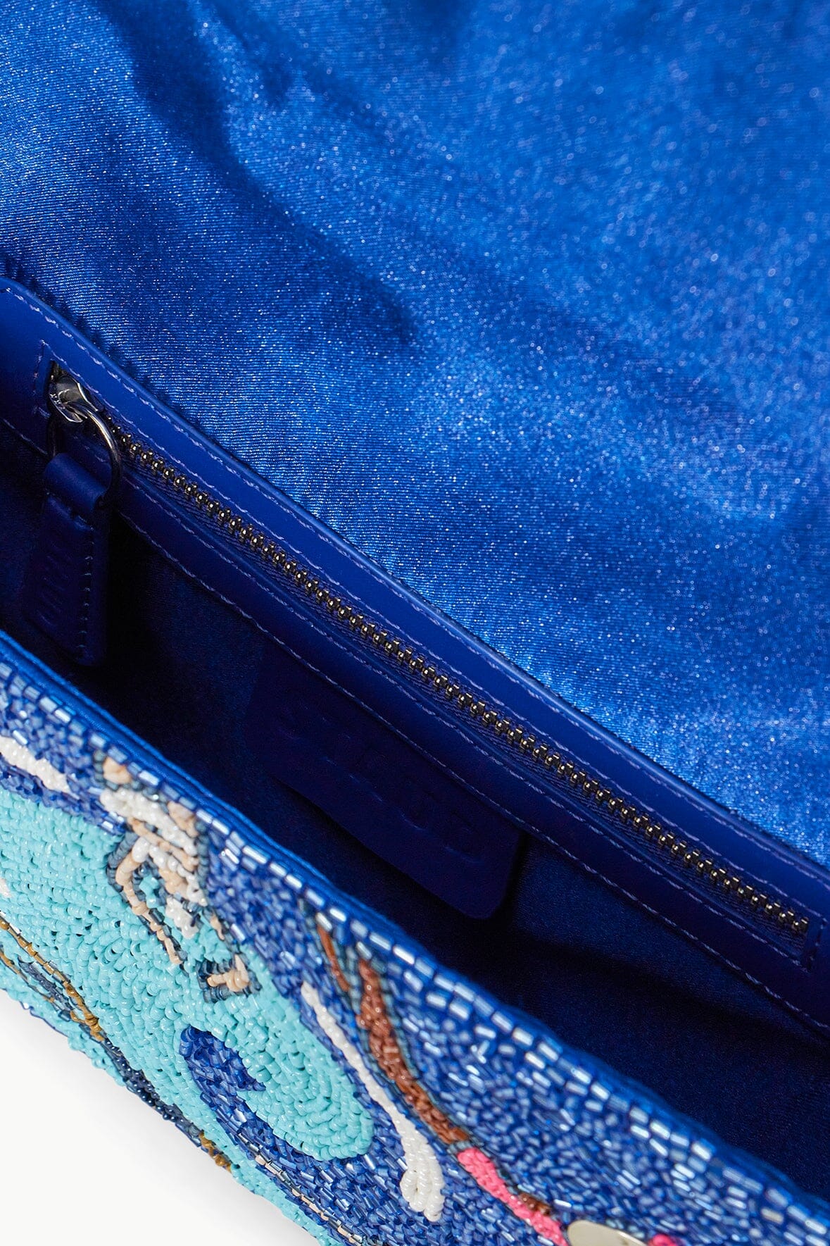 Beaded mini bag interior view with zipper and blue exterior swimmers print