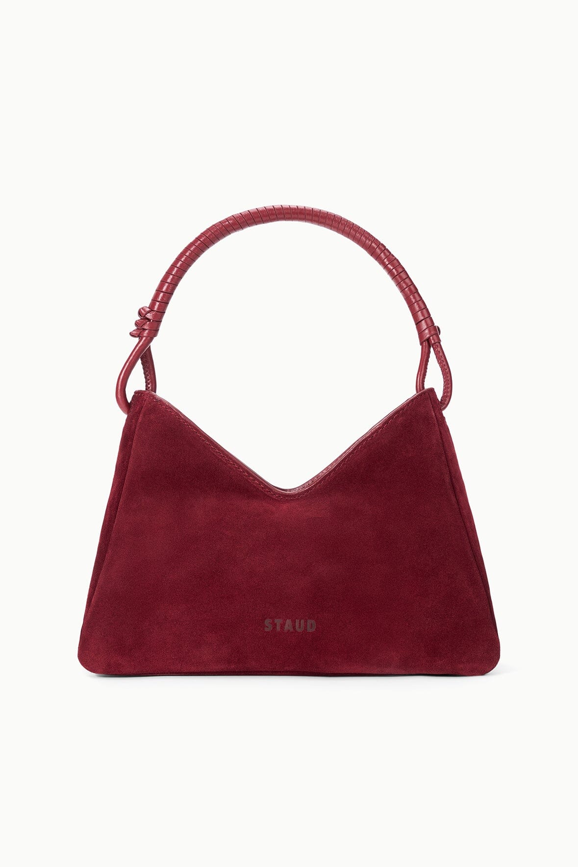 Burgundy suede shoulder bag with curved top handles and small logo patch