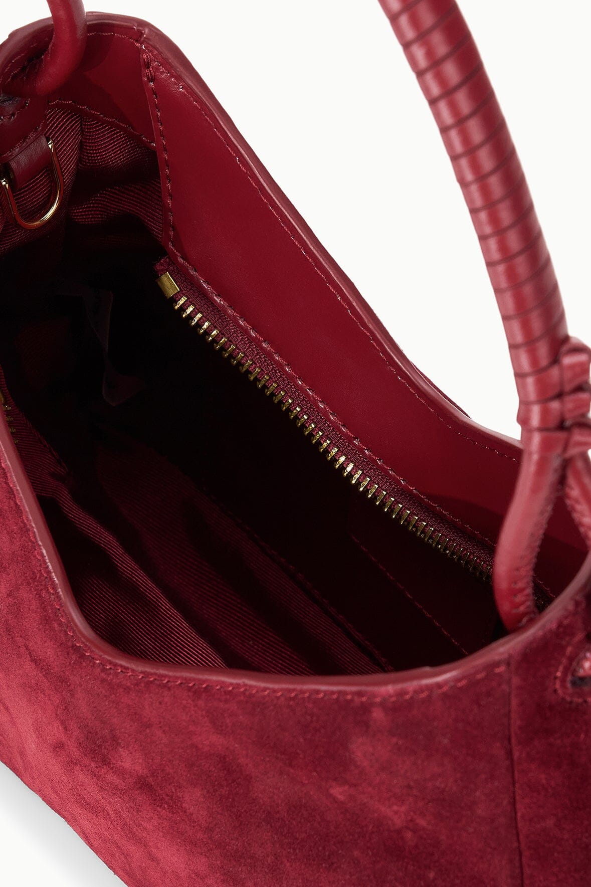 Burgundy suede shoulder bag interior with zipper pocket and fabric lining