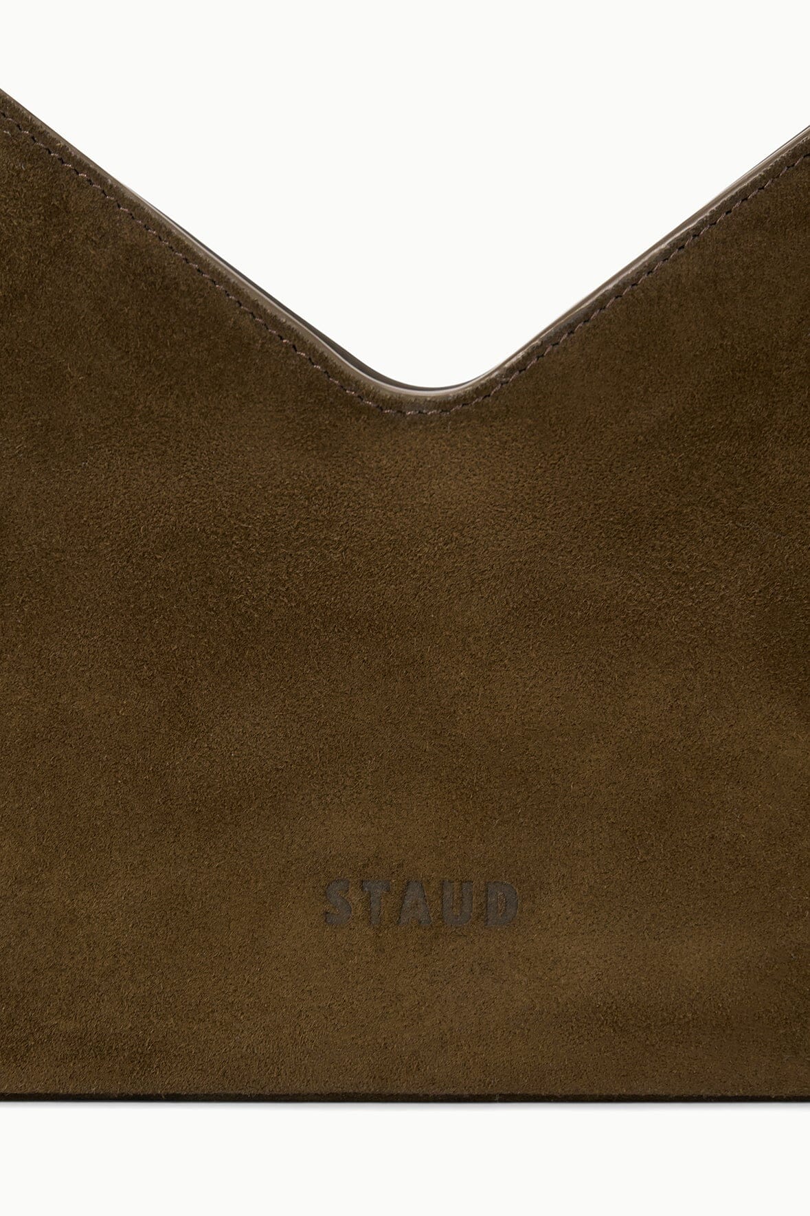 Truffle suede shoulder bag corner with embossed logo panel