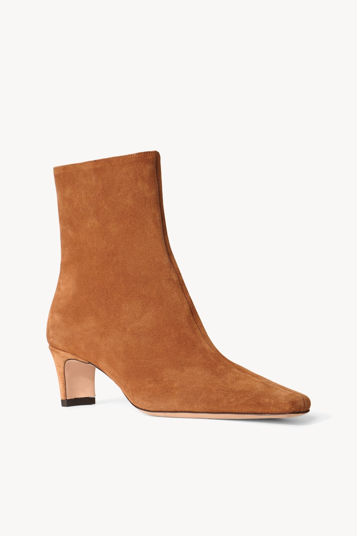 Tan suede ankle boot with low block heel and sleek pull-on shaft