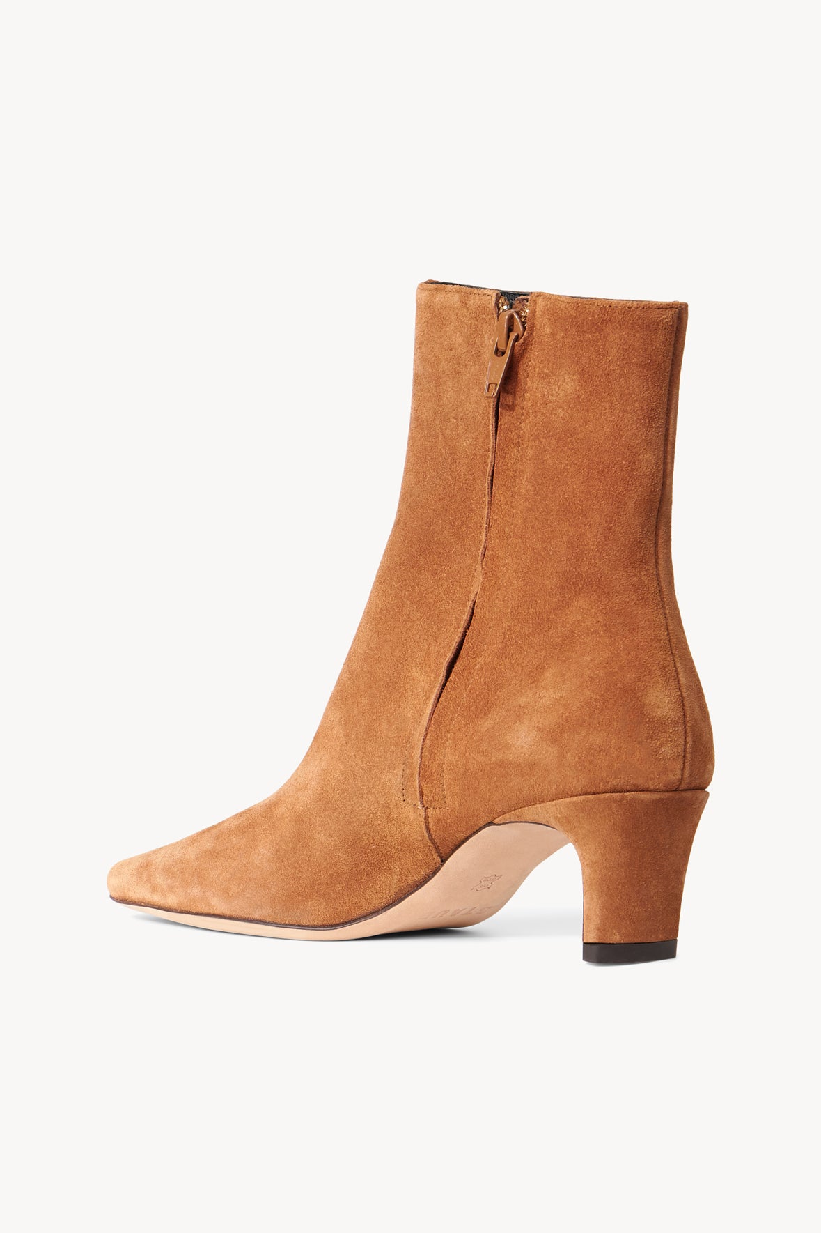 Tan suede ankle boot with side zipper, low block heel, and almond toe