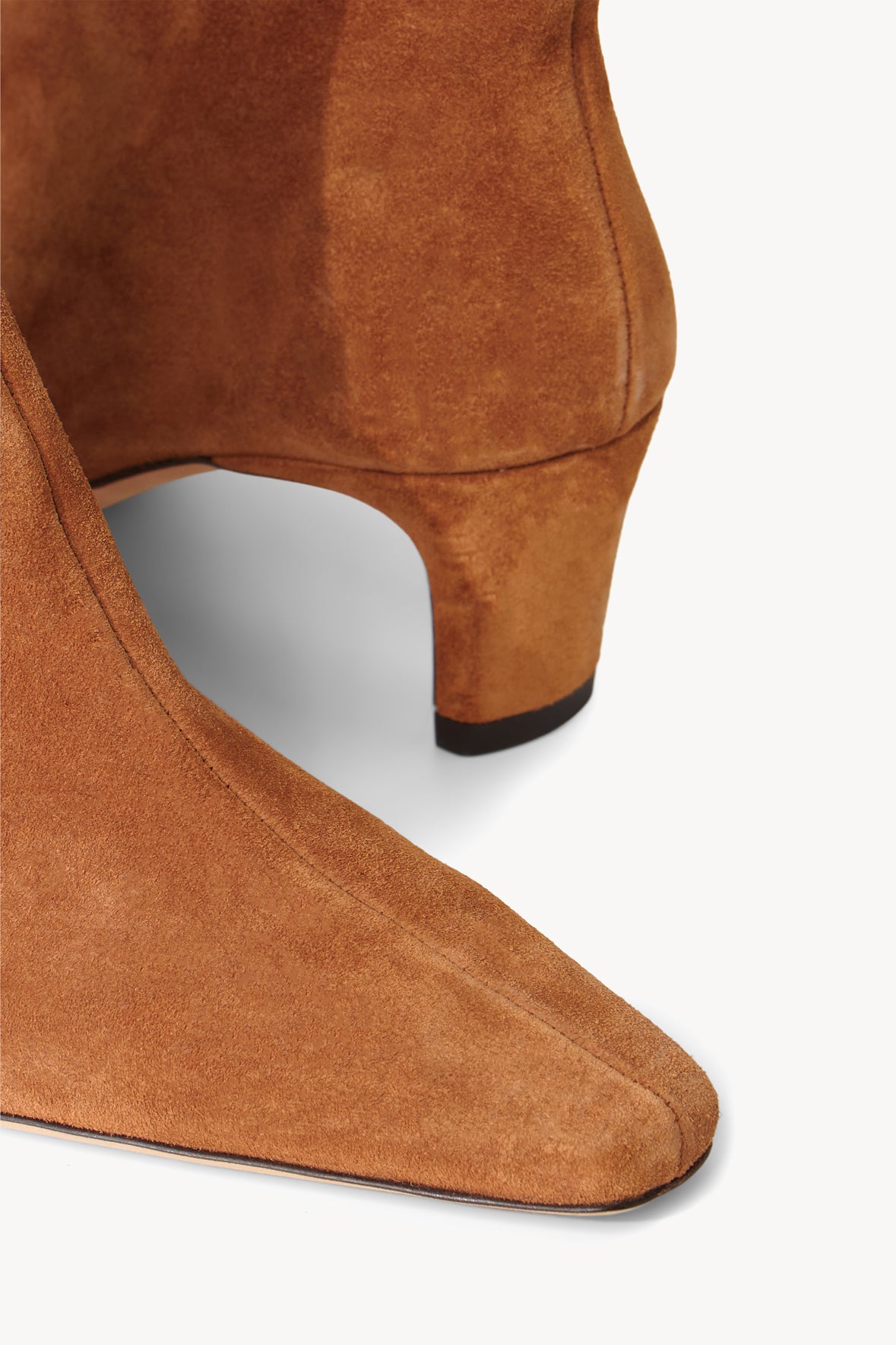 Tan suede ankle boot side view with low block heel and smooth sole
