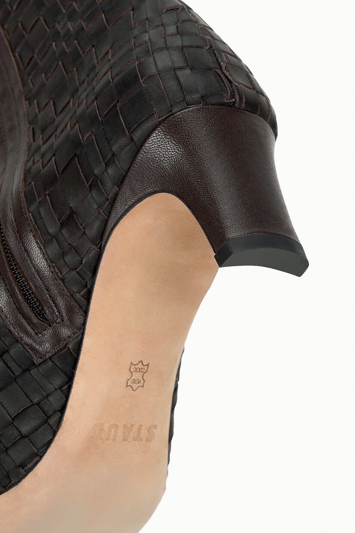 Close-up of dark espresso woven leather ankle boot, pointed toe and low heel