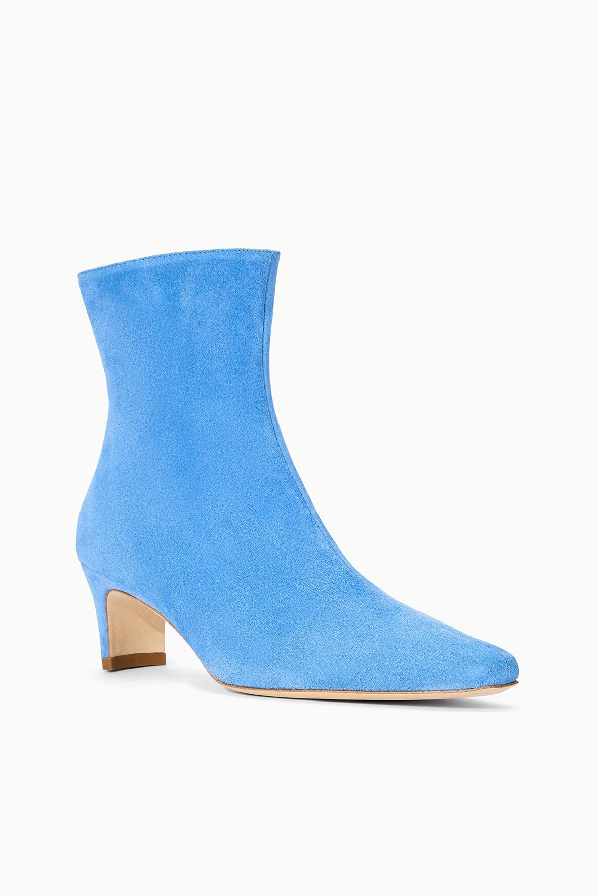 Blue suede ankle boot with stacked heel and sleek pull-on design