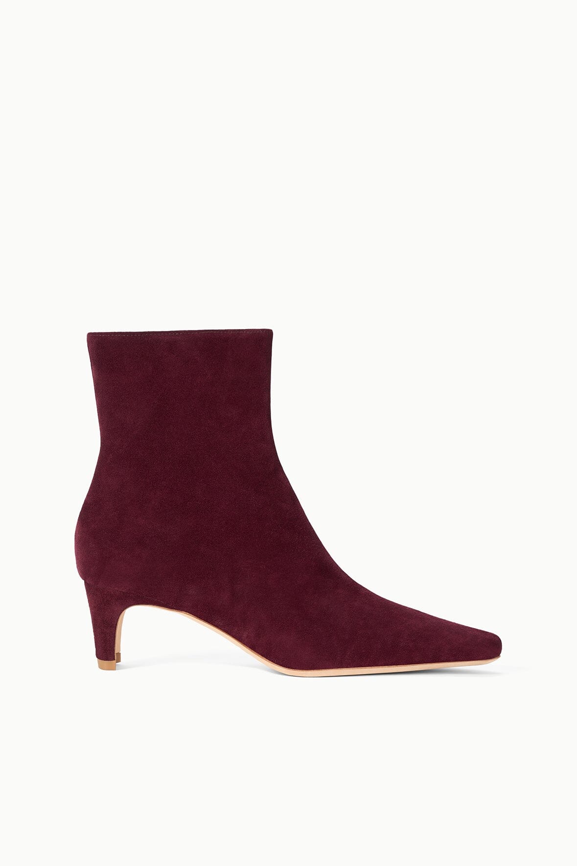 Suede ankle boot in syrah wine with low block heel and pointed toe.