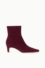 Suede ankle boot in syrah wine with low block heel and pointed toe.