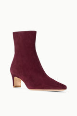 Suede ankle boot in syrah wine with low block heel and pull-on shaft.