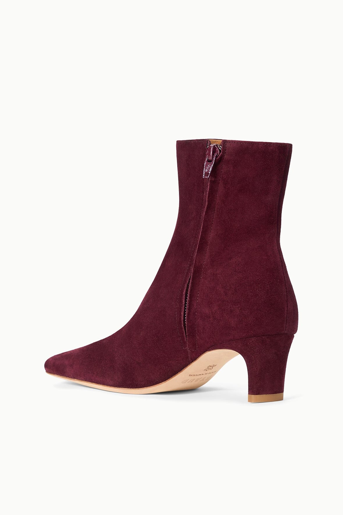 Suede ankle boot in syrah wine with side zipper and block heel.