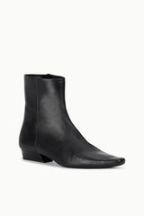 Black flat ankle boot with angled side profile and low block heel