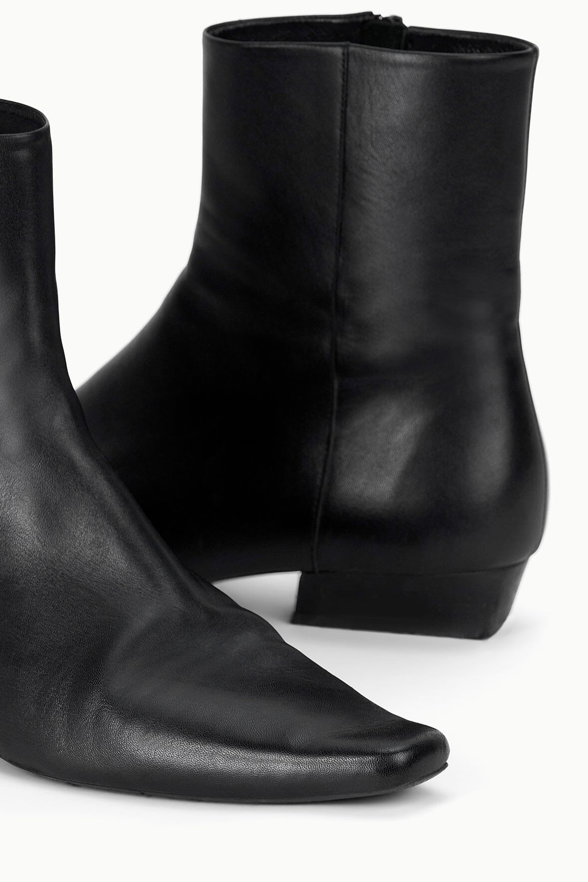 Black flat ankle boot close view of heel and side seam