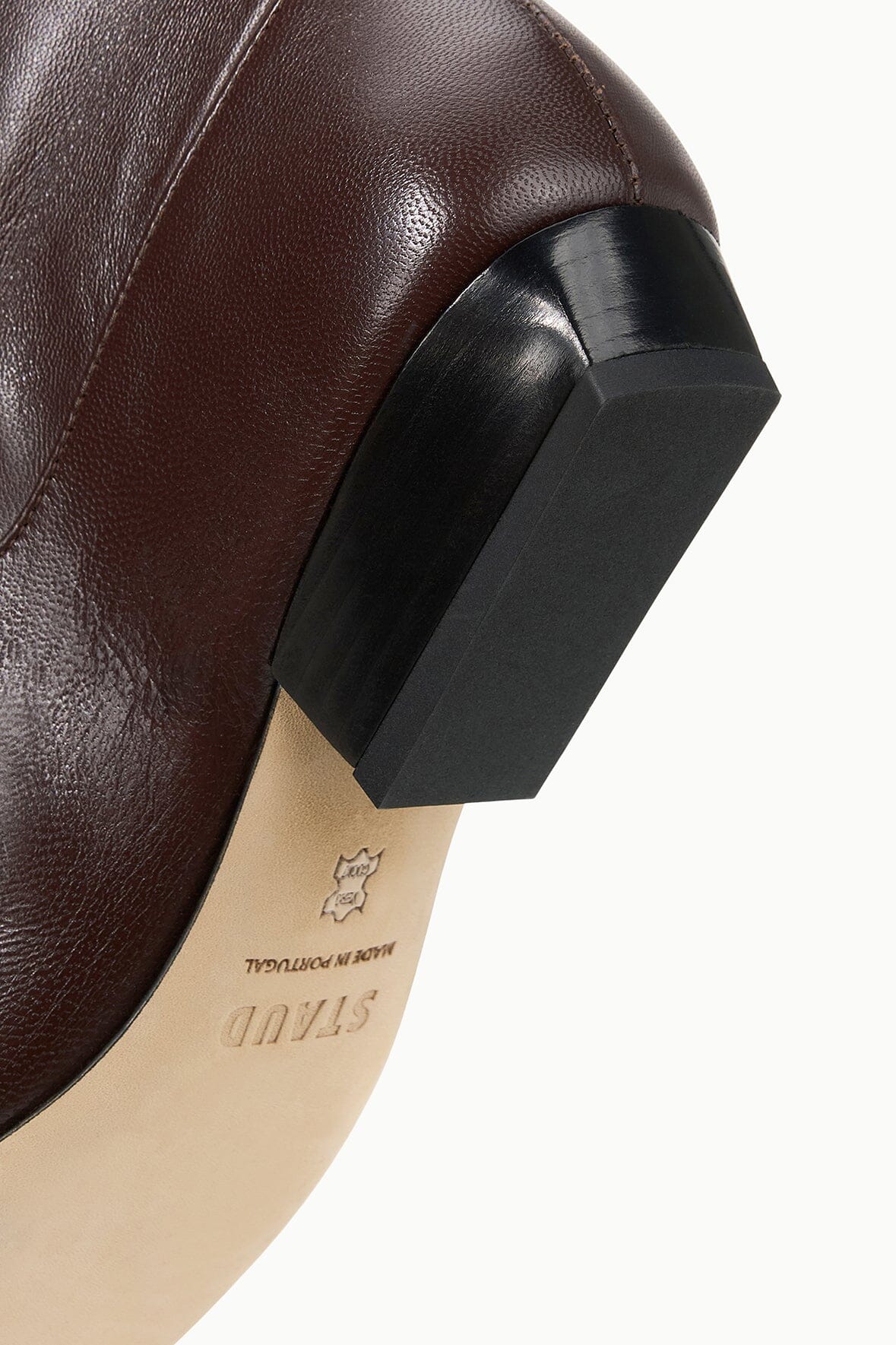 Espresso flat boot heel detail with thick block and smooth leather upper