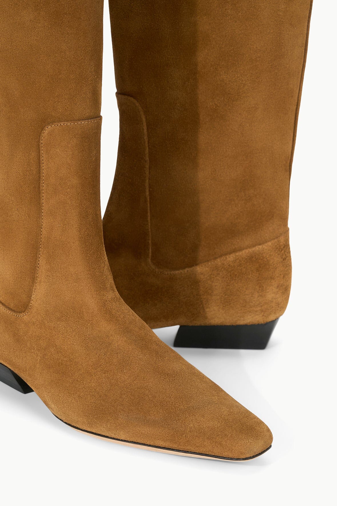 Tan suede flat boot with stitched upper and dark low heel