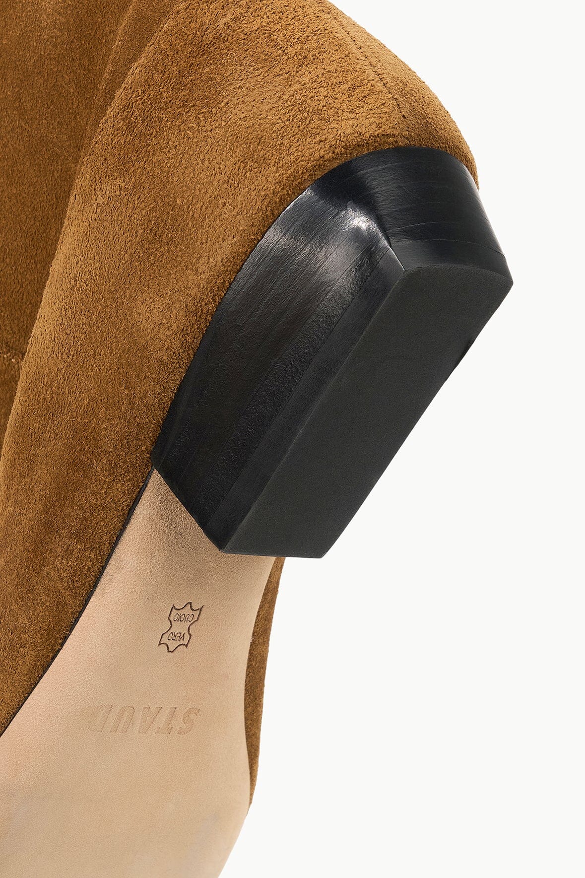 Tan suede flat boot with dark sole and low stacked heel detail