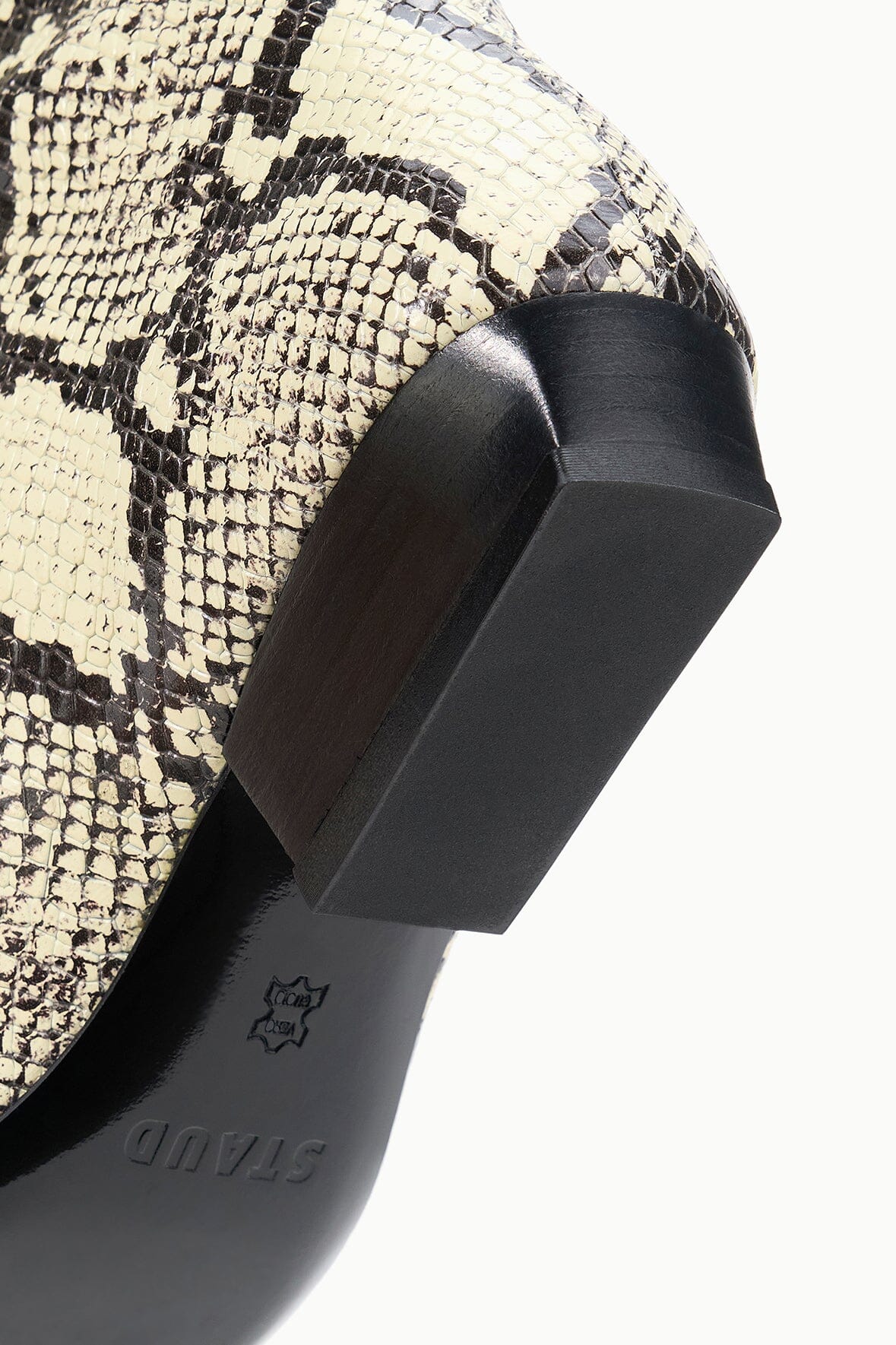Snake-print flat boot heel and side tab detail with black rubber sole