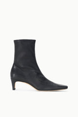 Black ankle sock boot with tapered toe and low block heel.