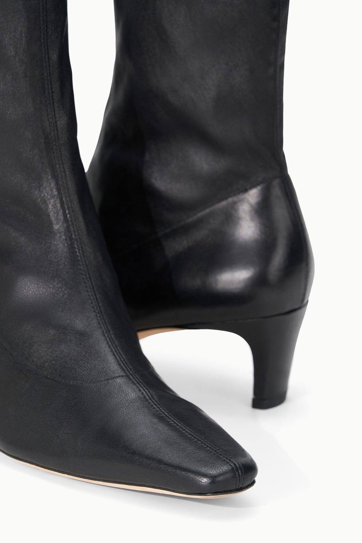 Black ankle sock boot showing side profile and low block heel.