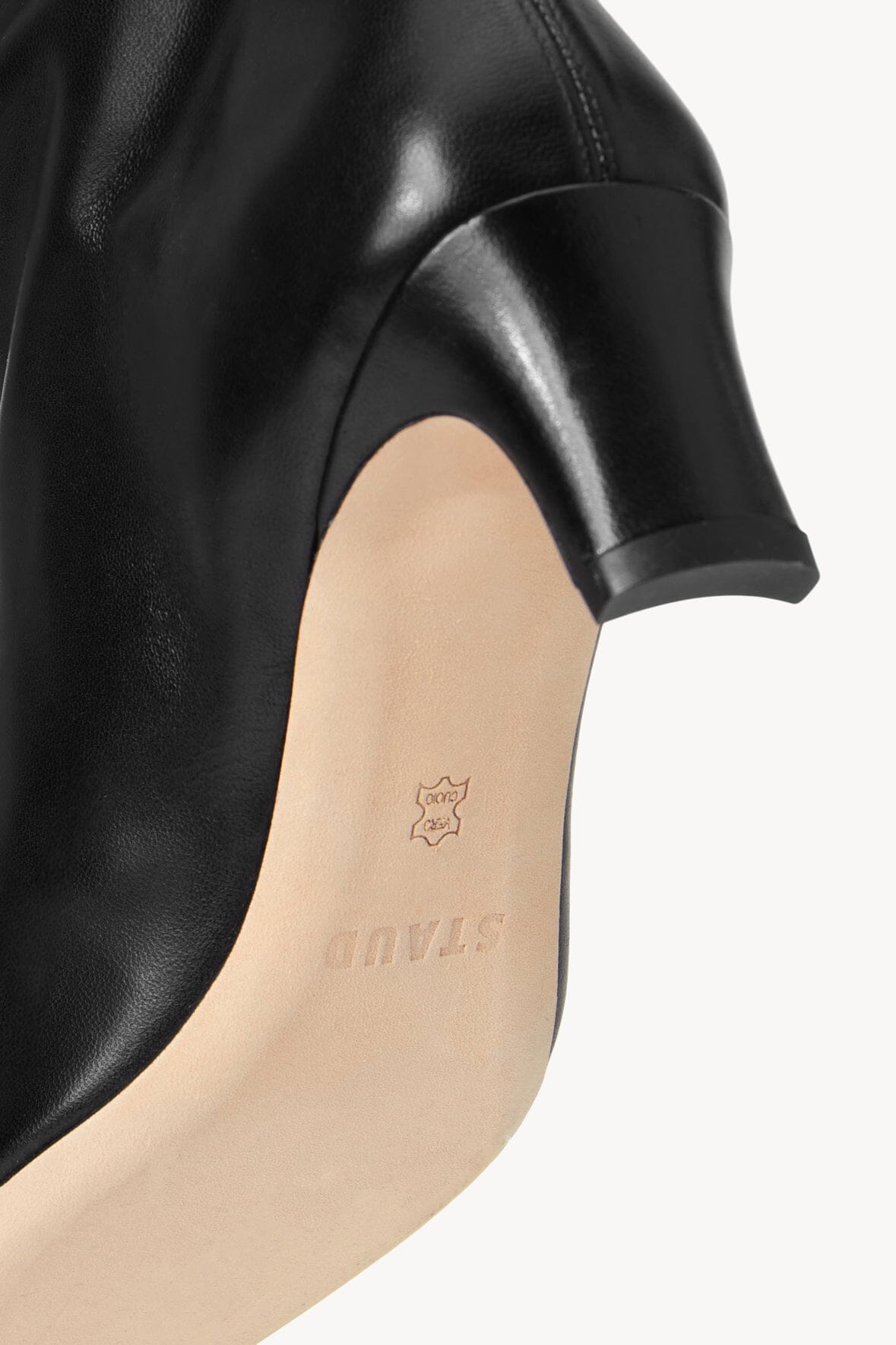 Black knee-high boot interior showing logo on the insole