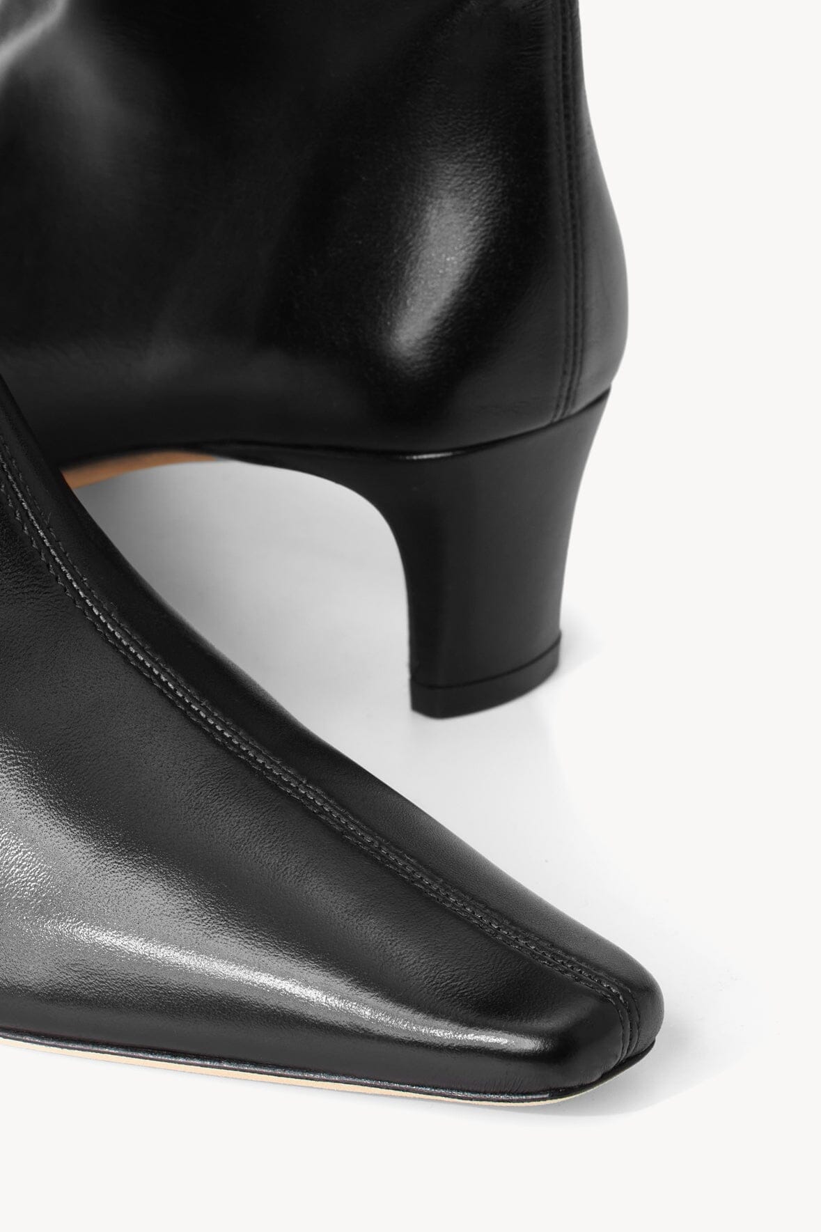 Black boot heel and stitched sole edge with low block heel