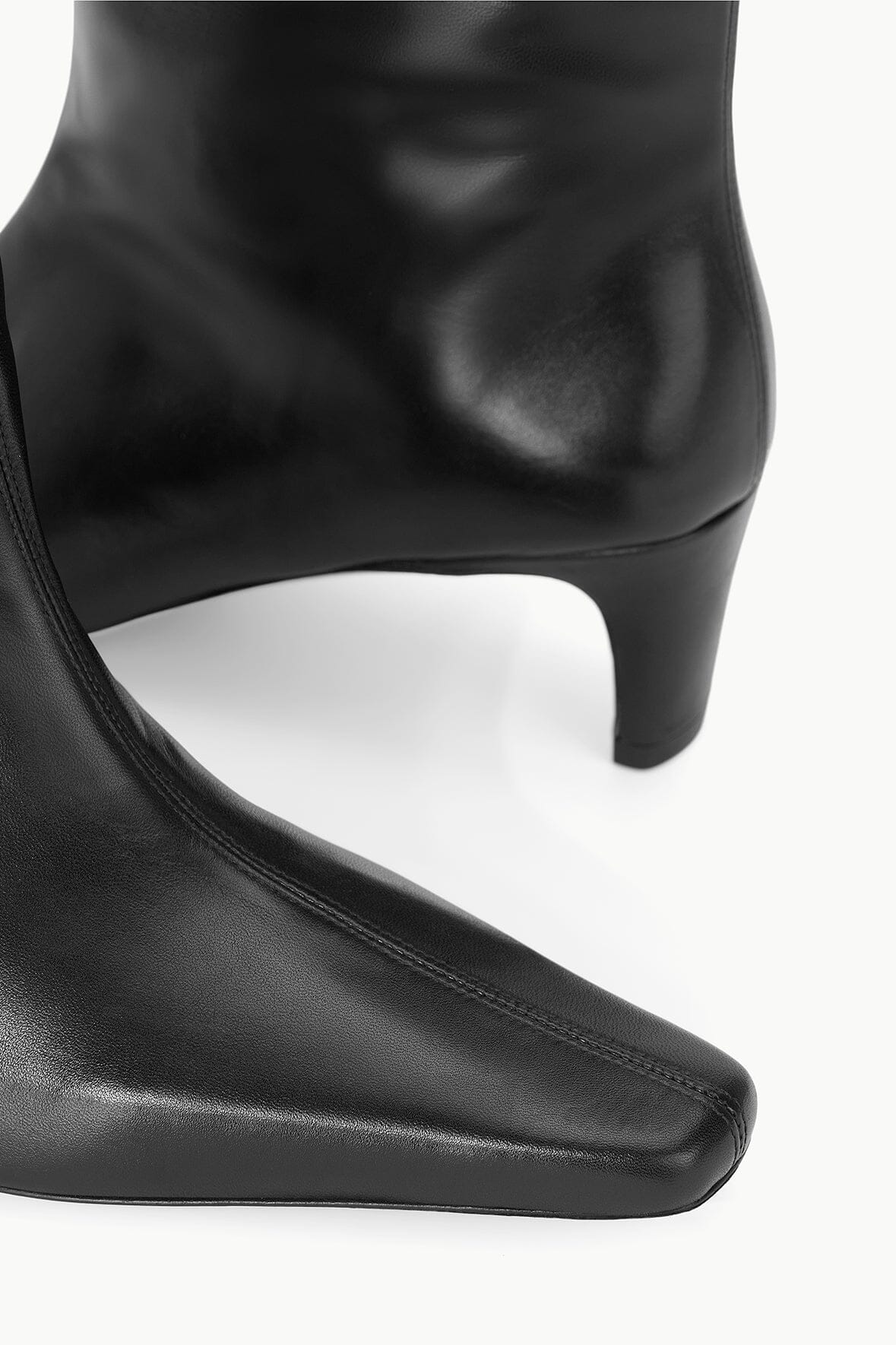 Black leather western boot showing curved toe and low block heel