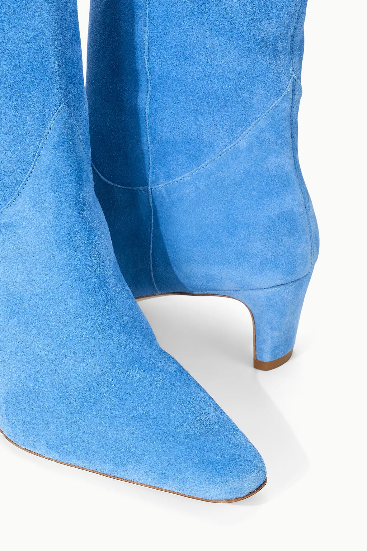 Light blue suede boot with low stacked heel and rounded back seam detail