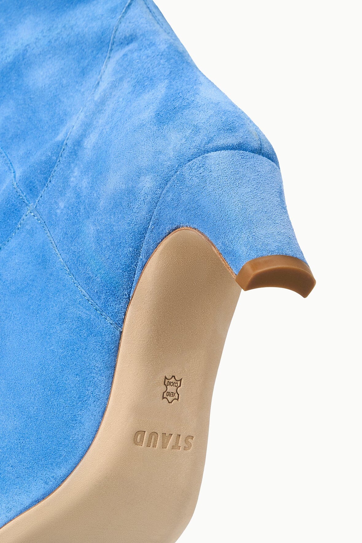 Light blue suede boot shaft with tan pull tab and star logo on lining