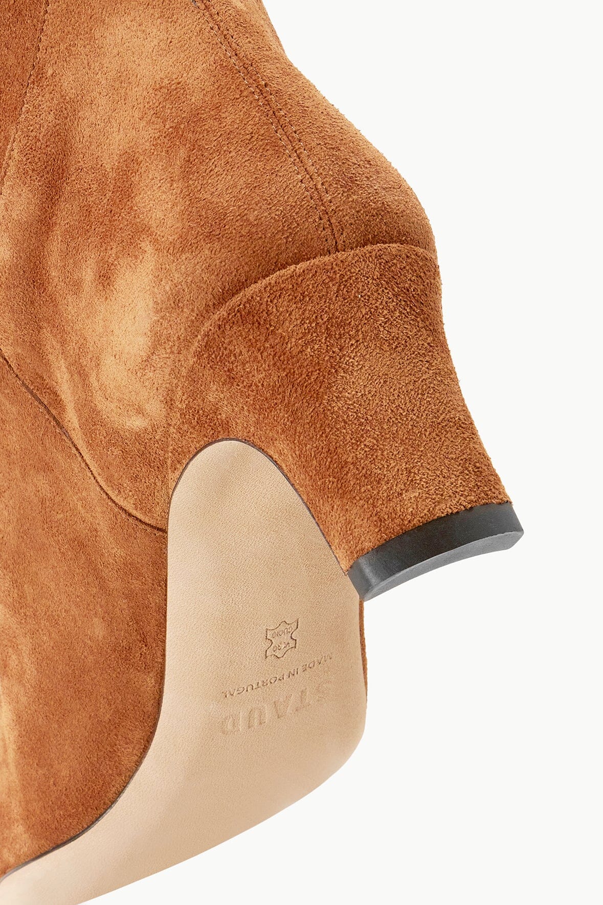 Tan suede boot with black heel cap and embossed insole