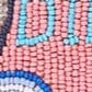 Beaded front panel close-up with embroidered letters and colorful border