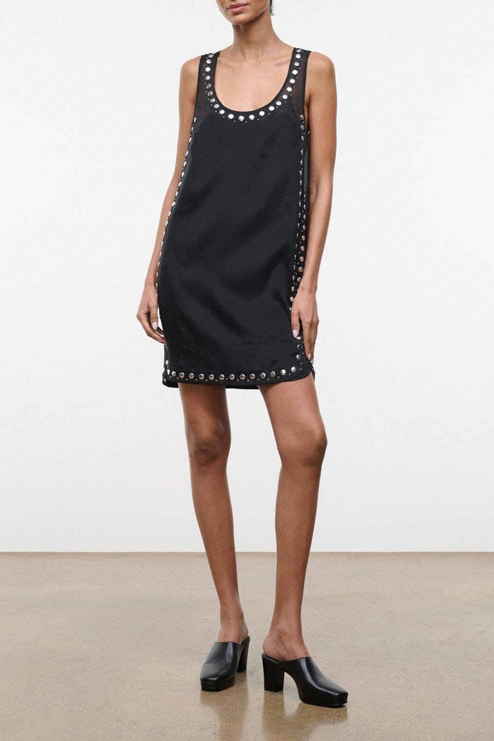 Black sleeveless studded shift dress with round neckline and button-like trim