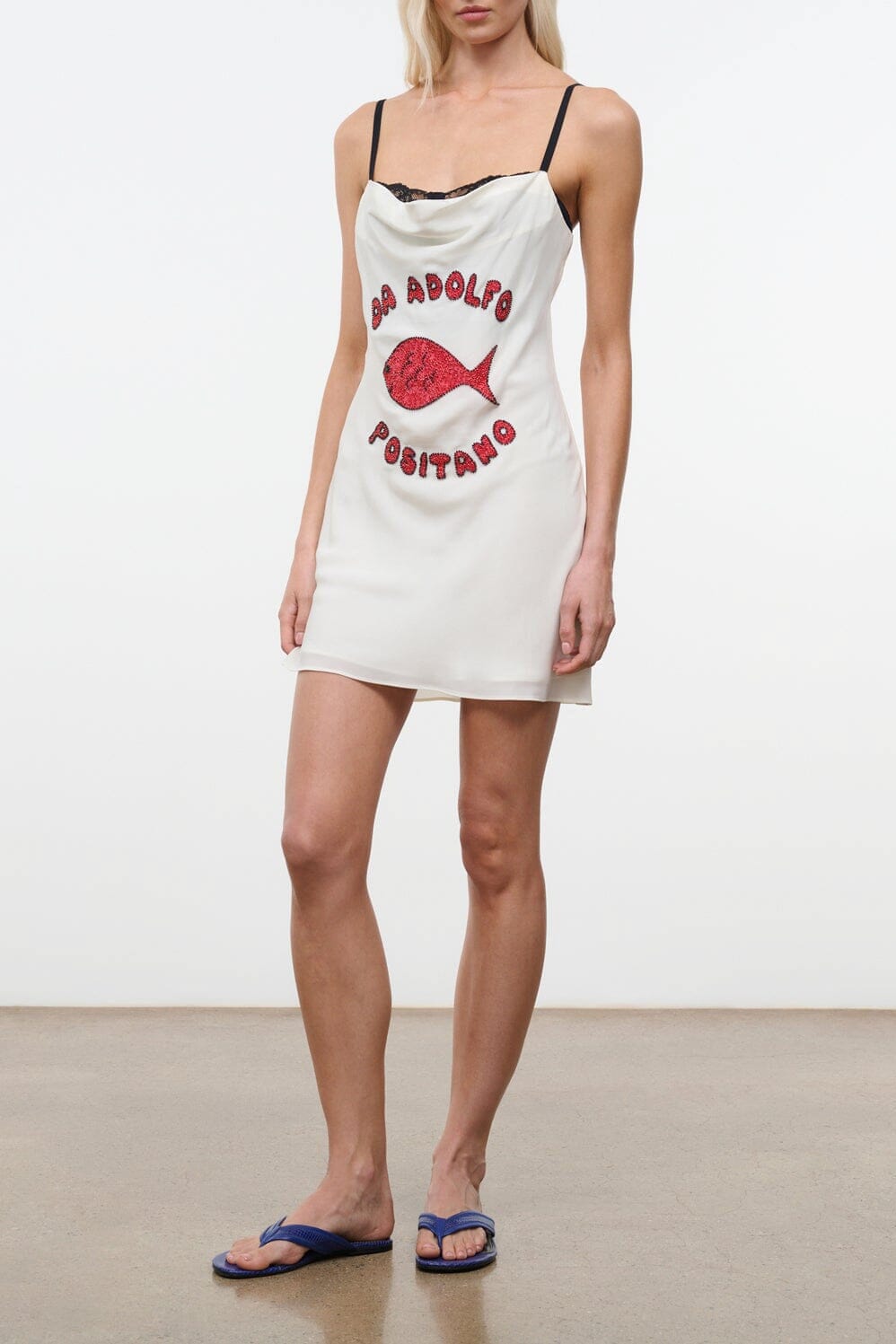 White silk mini dress with spaghetti straps, black trim, and DA ADOLFO Positano red fish print