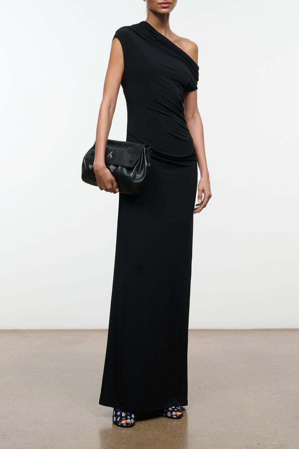 Black one-shoulder draped maxi dress, sleeveless with fitted silhouette