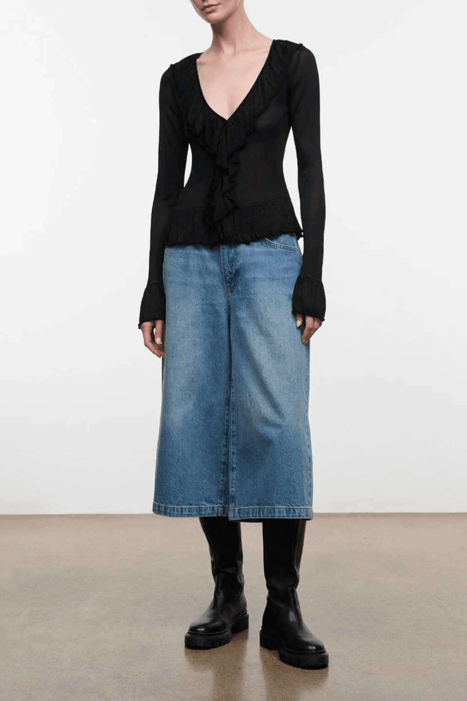 Black long-sleeve V-neck ruffled top with gathered front