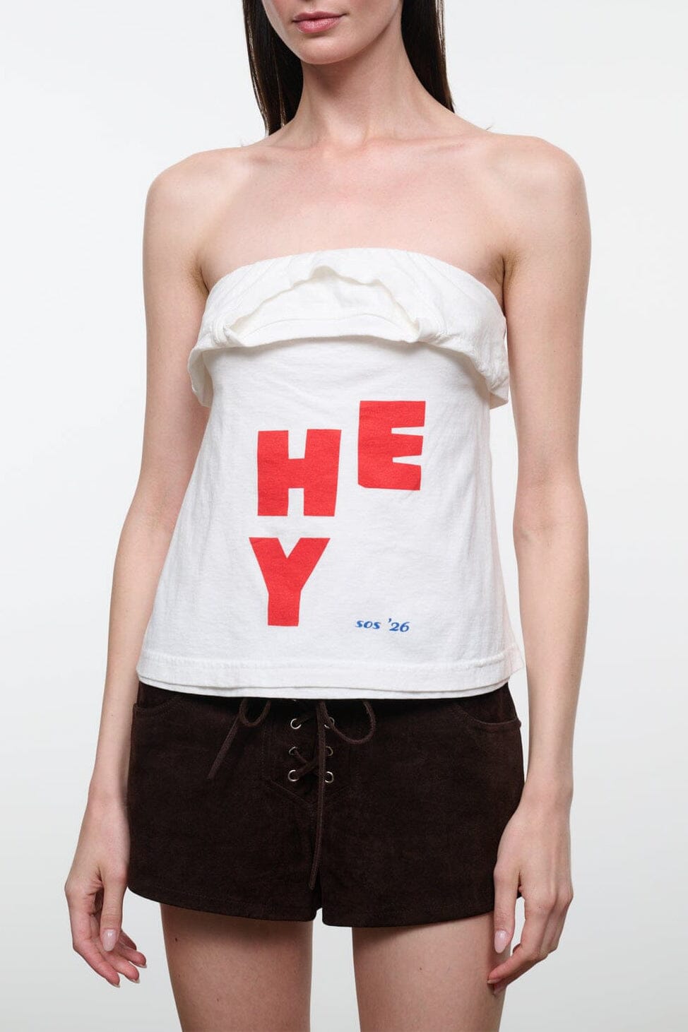Strapless white bandeau top with ruffled edge and bold red “HEY” print
