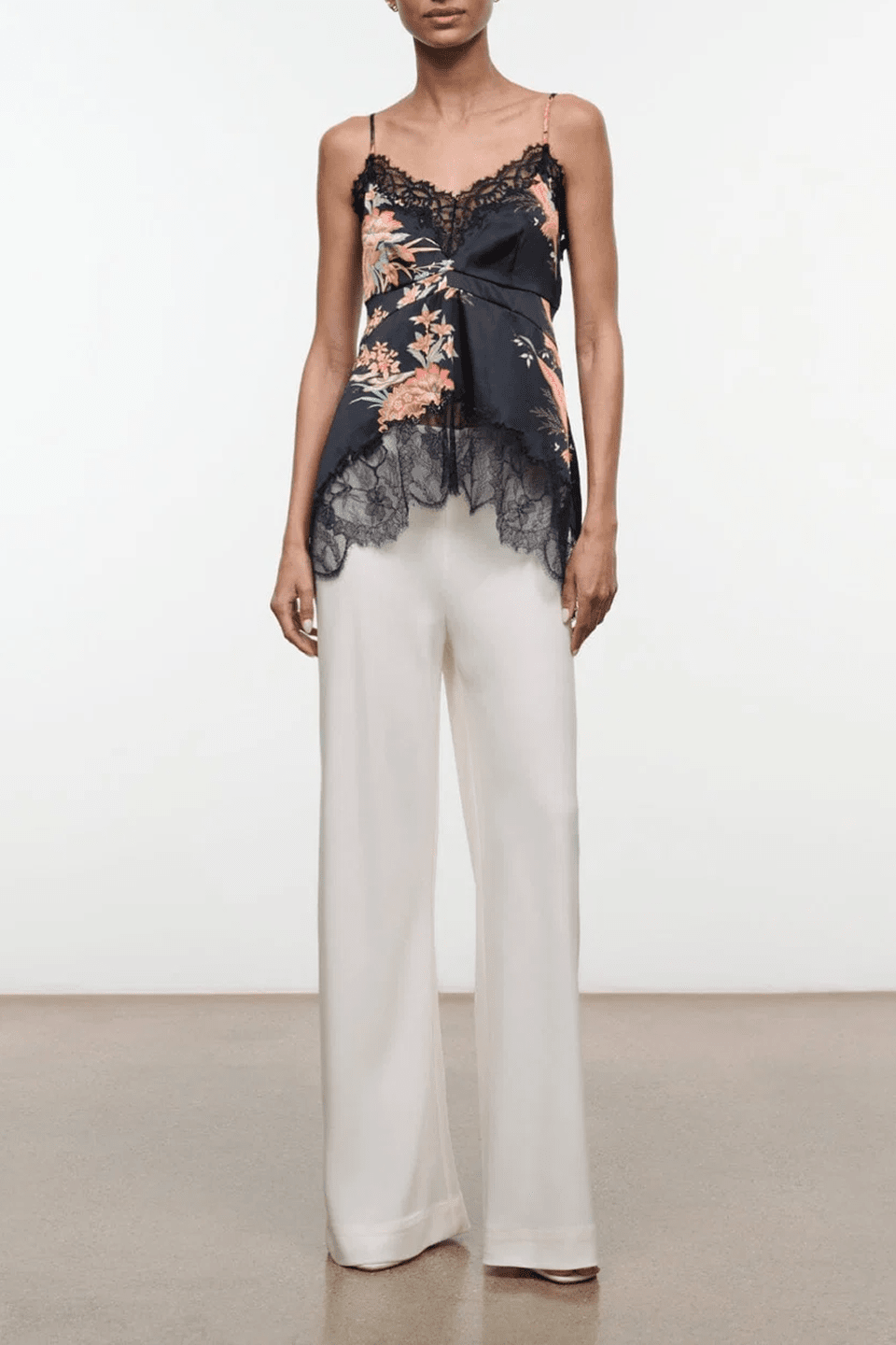 Black silk camisole top with floral embroidery, lace trim, and thin spaghetti straps