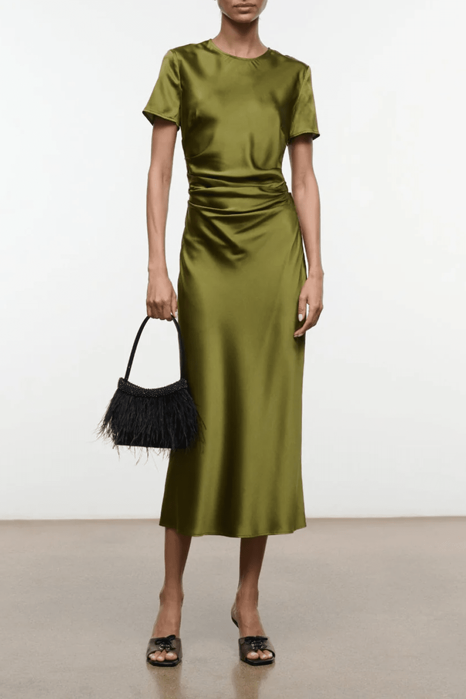 Silk dress in olive green with short sleeves, fitted waist, and midi length