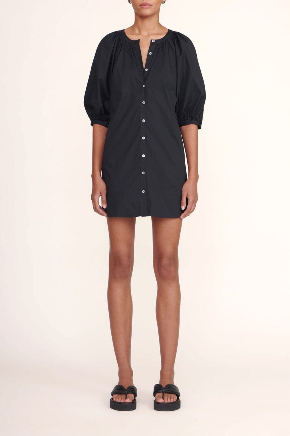 Black mini dress with V-neck button front and short puff sleeves