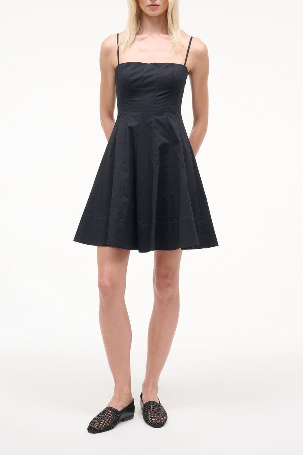Black sleeveless mini dress with fitted bodice and flared skirt